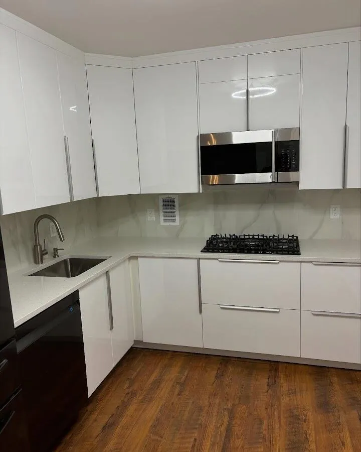 Restored kitchen with white cabinets after water damage in Hickam Housing